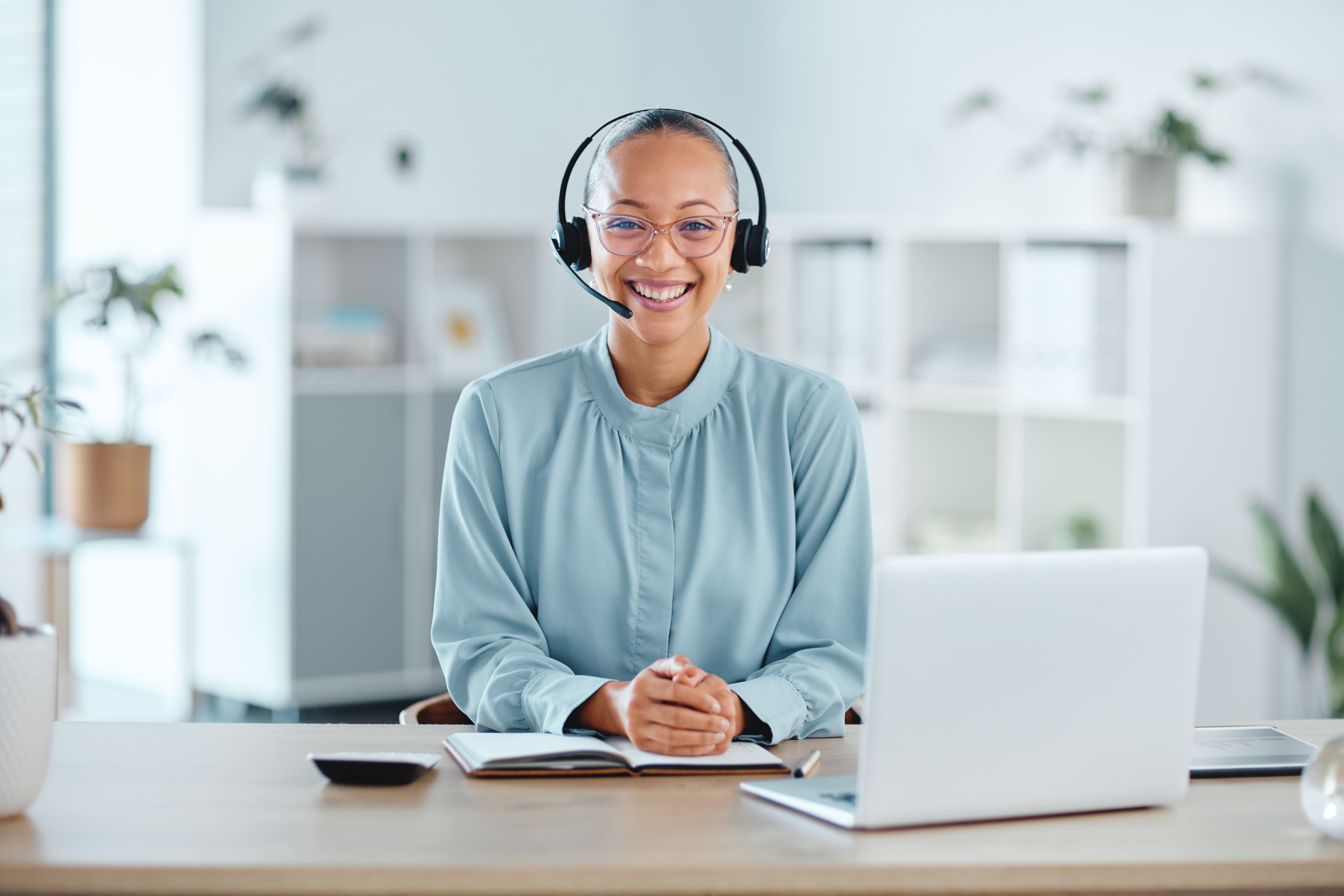 happy-and-confident-call-center-agent-sitting-in-f-2025-04-06-11-48-30-utc (1)