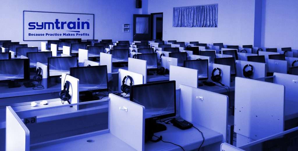 Contact center riddled with empty cubicles due to the notoriously high turn-over rate in the contact center that has a SymTrain: Because Practice Makes Profits logo on the wall. 